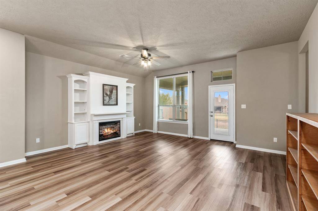 Warm living room with built in cabinetry and electric fireplace to provide you with a great place to spend special moments with your family!