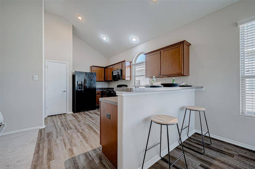 The kitchen offers a stylish breakfast bar with room for seating, making it a perfect spot for casual meals or entertaining.