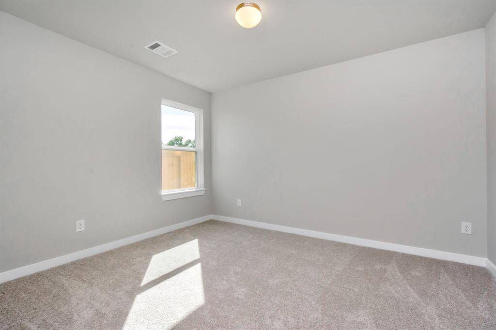 Generously sized secondary bedrooms featuring spacious closets, soft and inviting carpeting underfoot, large windows allowing plenty of natural light, and the added touch of privacy blinds for your personal retreat. Sample photo of completed home with similar floor plan. As-built interior colors and selections may vary.