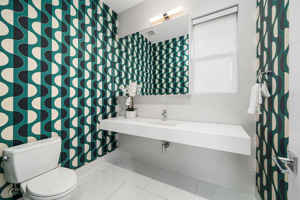The 1st floor powder bathroom is sleek, modern and equipped with the perfect punch of color and design!