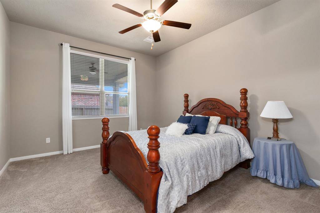 The primary is located near the rear of the home for added privacy. With an abundance of space, it makes room for a large bed and other furniture pieces.
