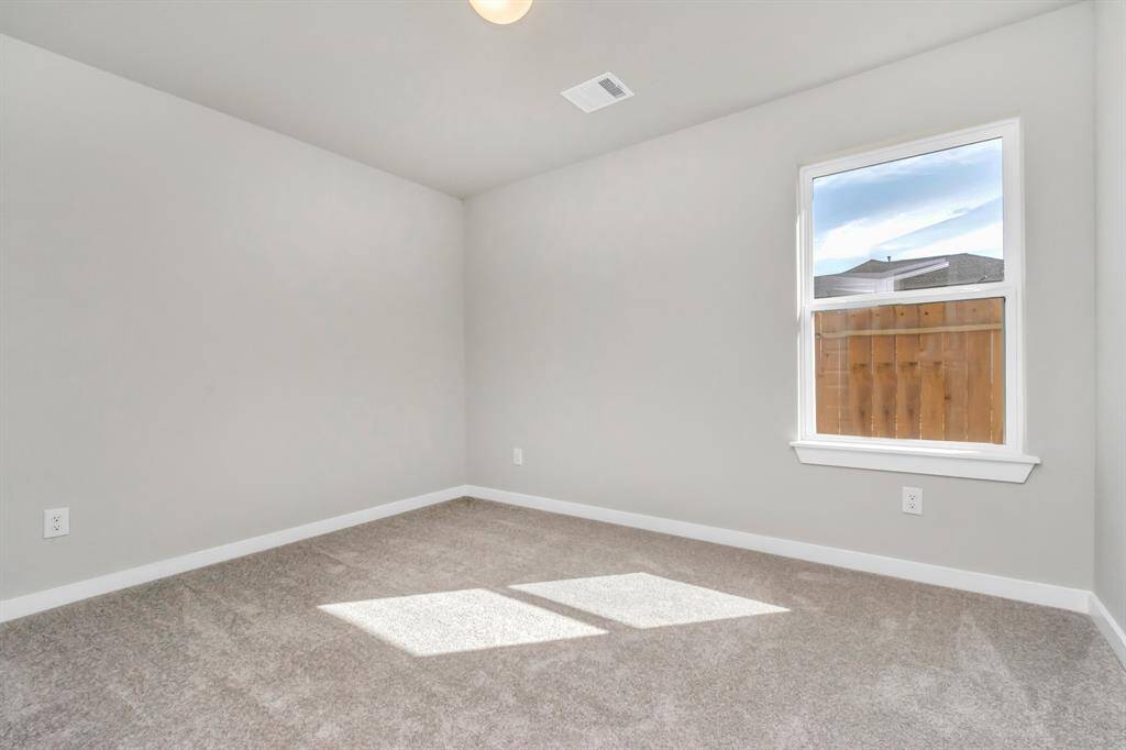 Generously sized secondary bedrooms featuring spacious closets, soft and inviting carpeting underfoot, large windows allowing plenty of natural light, and the added touch of privacy blinds for your personal retreat. Sample photo of completed home with similar floor plan. As-built interior colors and selections may vary.