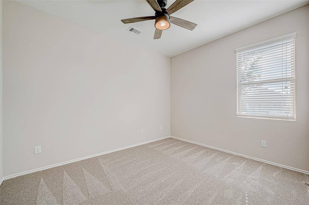 This bright and welcoming bedroom offers a neutral color palette, BRAND-NEW carpeting, and a modern ceiling fan for added comfort. A large window fills the room with natural light, creating an inviting atmosphere. Perfect for use as a guest room, home office, or personal retreat, this space is both functional and versatile.