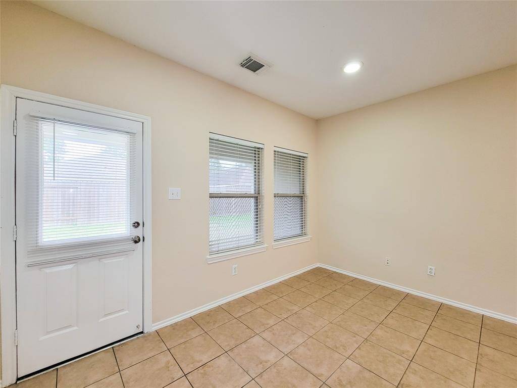 Ample Breakfast Area.  Door leads to Covered Patio & backyard.