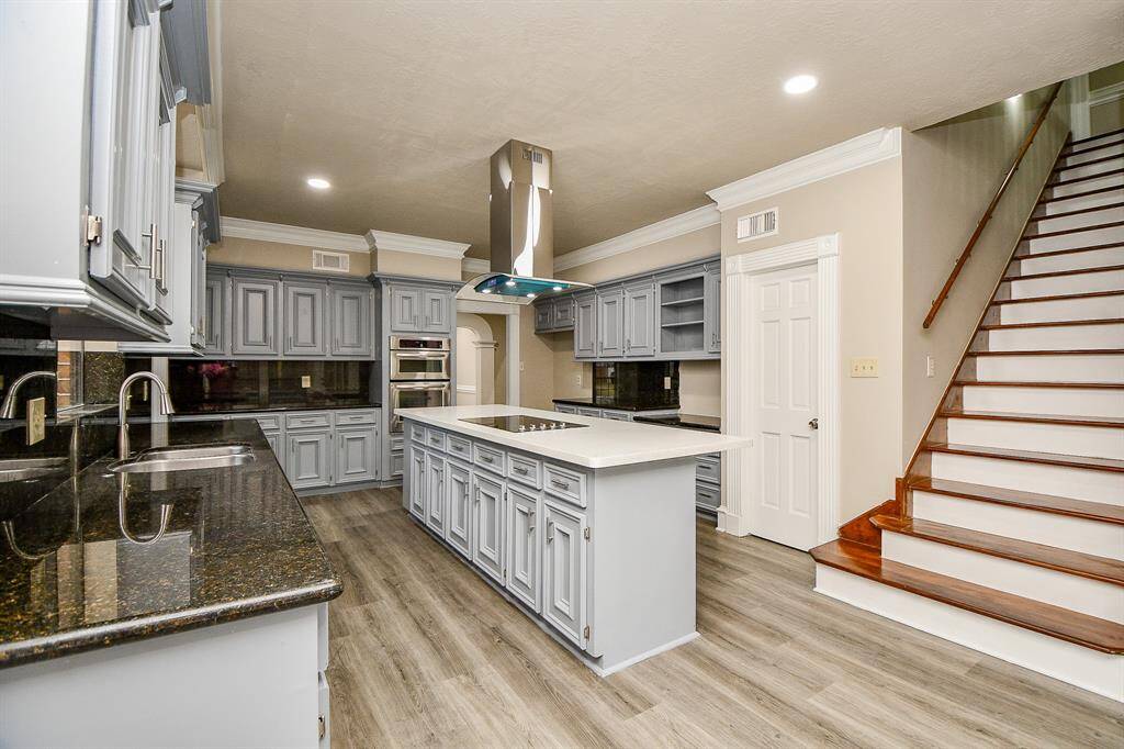 This more casual living space seamlessly extends from the breakfast nook, boasting an abundance of large windows that bathe the room in natural light. The exquisite architectural details that grace the rest of the home continue to impress in this inviting area.