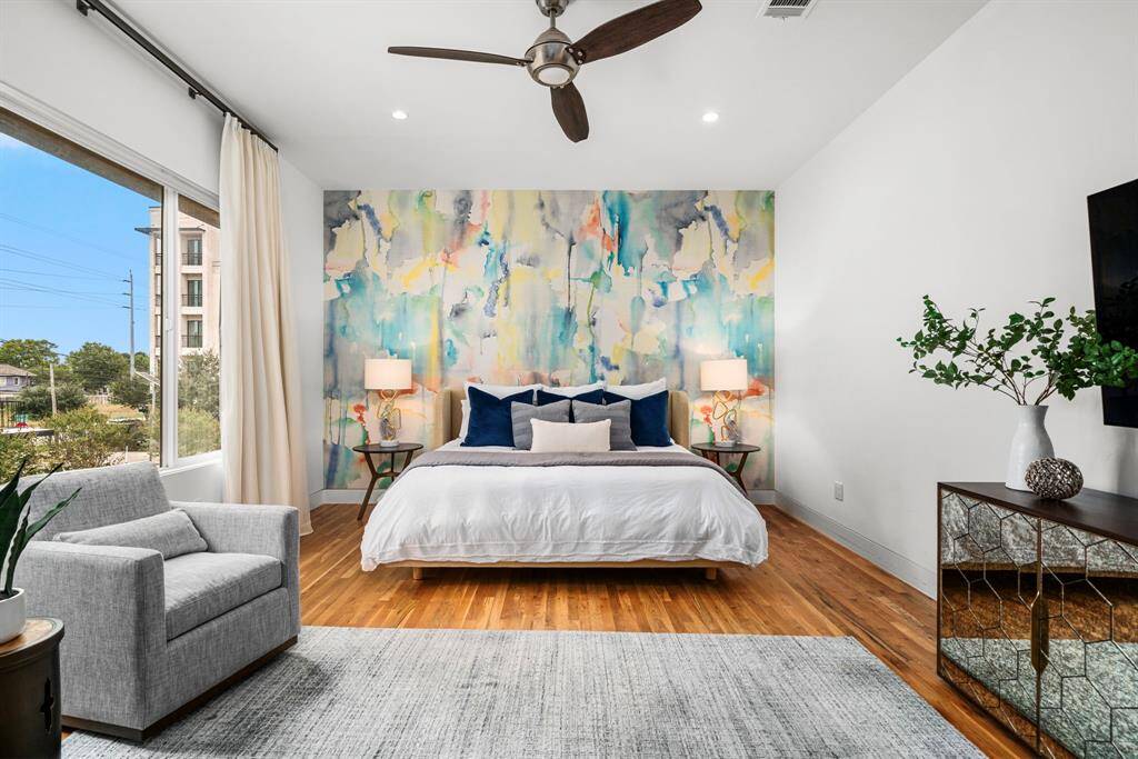 Oak hardwood flooring throughout the 2nd and 3rd floor. The large window in the primary suite allows generous natural light in, or utilize the black-out shades if you wish to sleep in. Custom drapery conveys with the home.