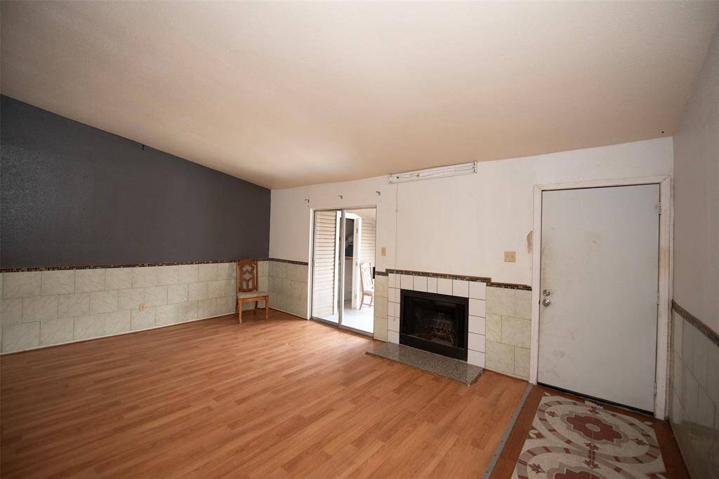 Entry to the home is a large living area with fireplace and sliding door to a balcony.