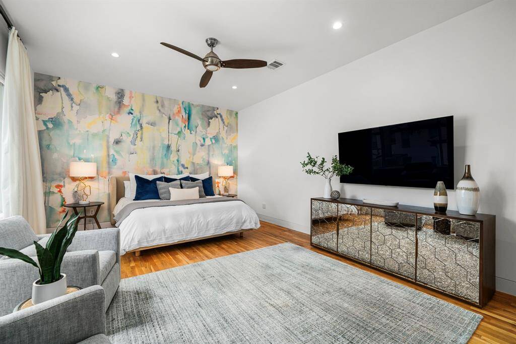 Strategically placed design elements include this Philip Jeffries wall of color in the primary bedroom.