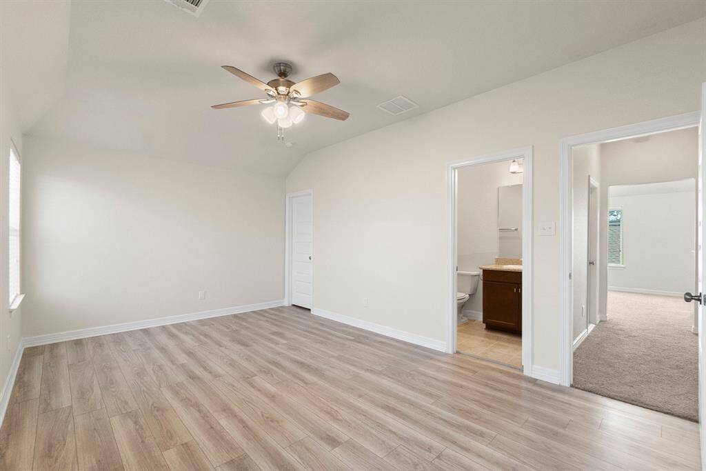 Generously sized secondary bedroom with luxury vinyl flooring and en suite bathroom