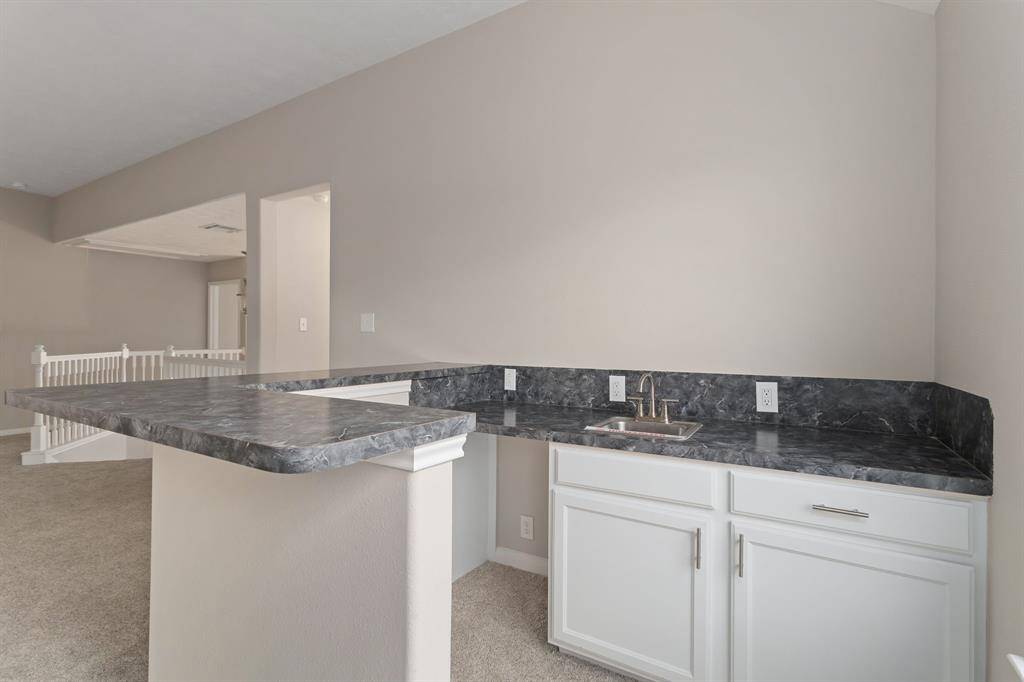 The upstairs game room has a wet bar area!