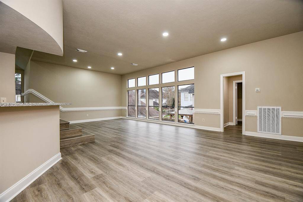 This luxurious primary bathroom is a true oasis, featuring a separate soaking tub and shower, each graced with its own window to bathe the space in natural light. Abundant storage is provided with two generously sized walk-in closets.