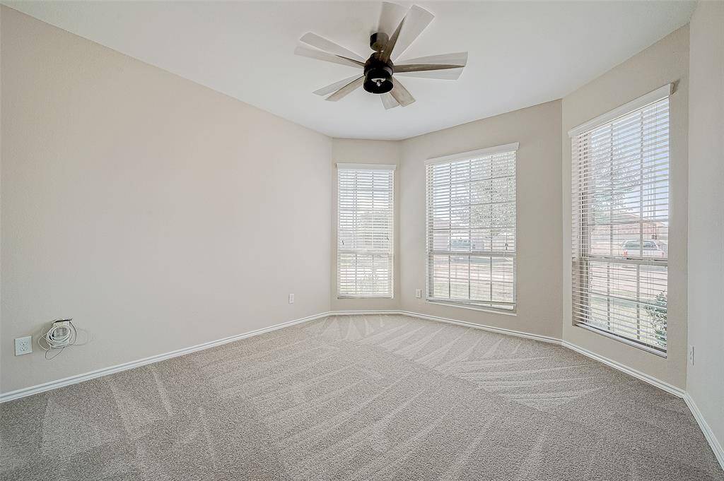 Another view of this room shows it bathed in natural light thanks to its elegant bay windows, offering a bright and airy feel.