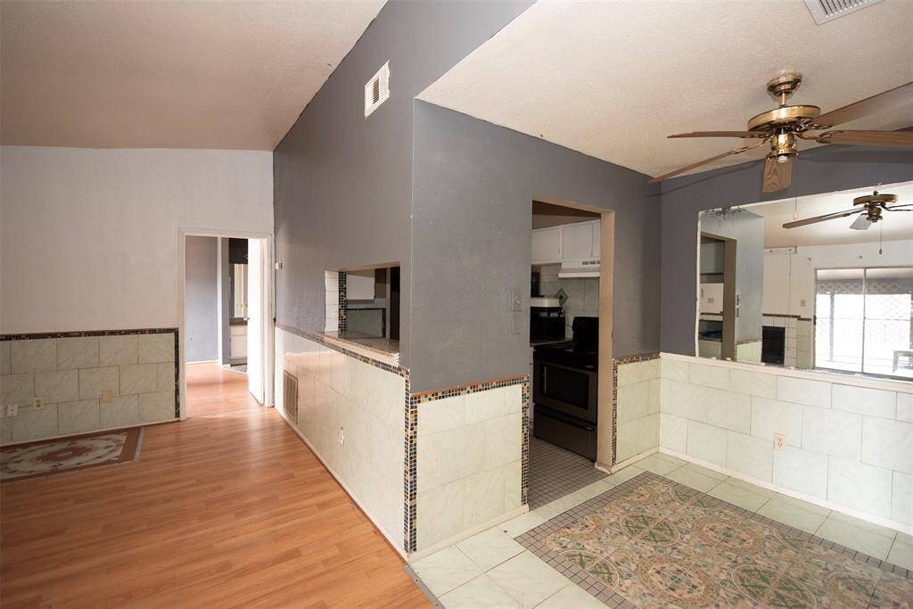 As you approach the kitchen is a breakfast bar and dining area.