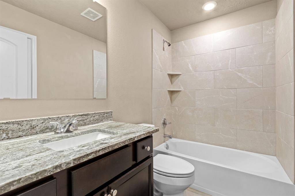 Hall bathroom serves secondary bedrooms and guests.