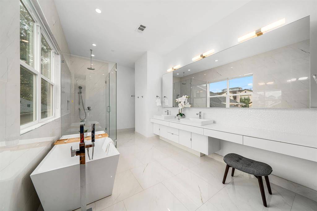 Dual sink vanity with with wall to wall countertop space, as well as plenty of storage.