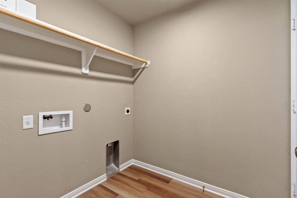 The laundry room is nestled next to the kitchen making it easy for multi-tasking.