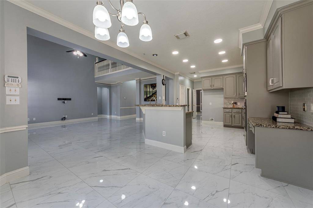 Large breakfast area adjacent to the spacious kitchen with recessed canned lighting and crown molding.