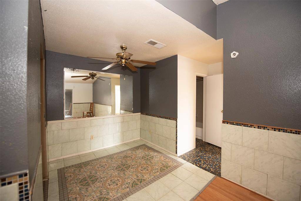 Mirrored dinining area makes the space look larger. Will easily fit a table for 4.