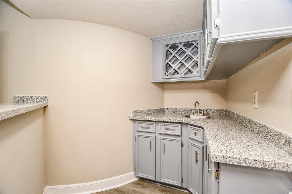 This vantage point from within the walk-in closets reveals the true grandeur of the primary bathroom, showcasing its spacious layout and elegant design. The toilet area is discreetly tucked away behind a privacy door, while still offering delightful glimpse of the sparkling pool just outside your bedroom window!