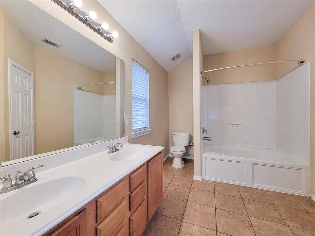 Primary Bathroom with dual sink, Garden Tub with shower.