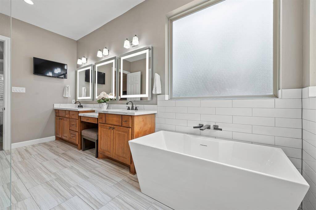 Stand alone tub and light up mirrors add an extra touch of class