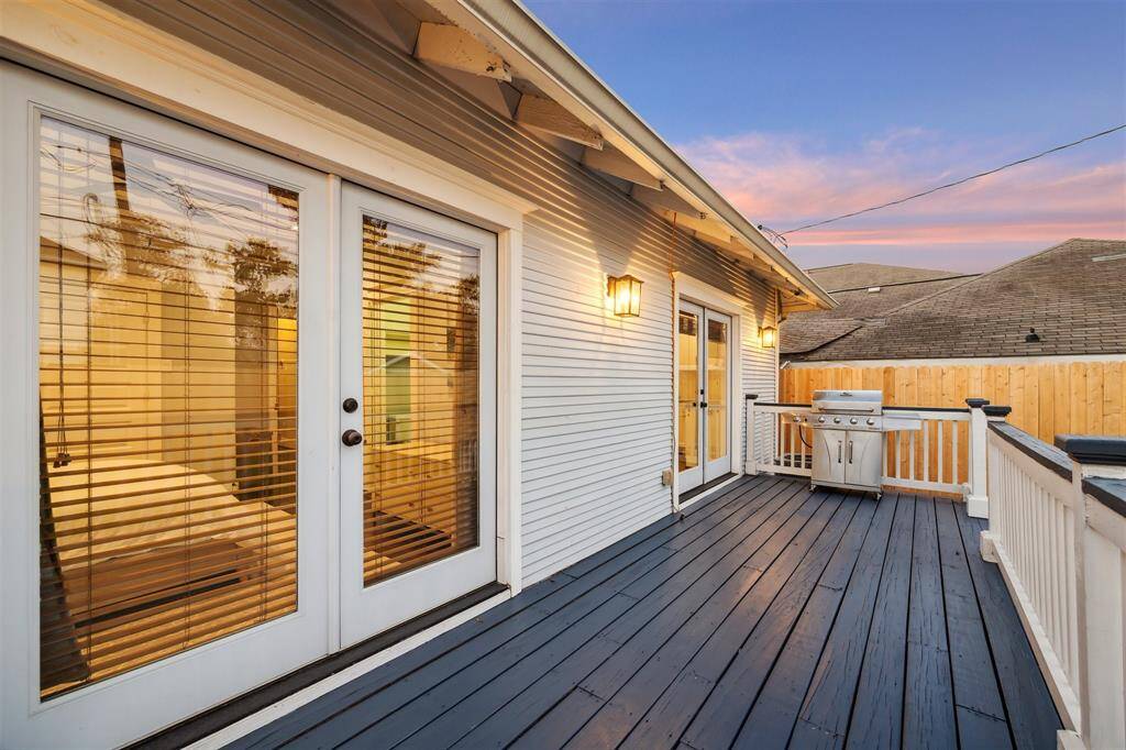 The back porch offers ample space to entertain and enjoy the outdoors in this fully fenced space.