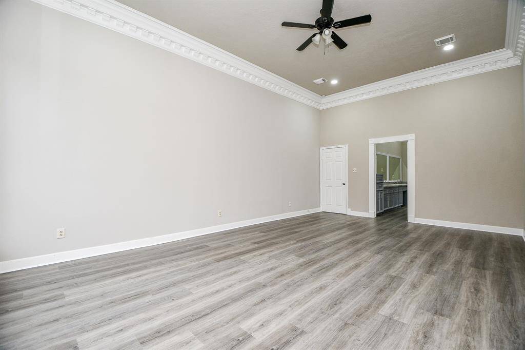 This expansive game room offers endless possibilities for entertainment and relaxation. A wet bar adds convenience for hosting gatherings, while a staircase leads to a cozy loft area with a fireplace – the perfect spot for curling up with a good book. The room's soaring ceilings and abundant natural light create an inviting atmosphere for family and friends to gather.