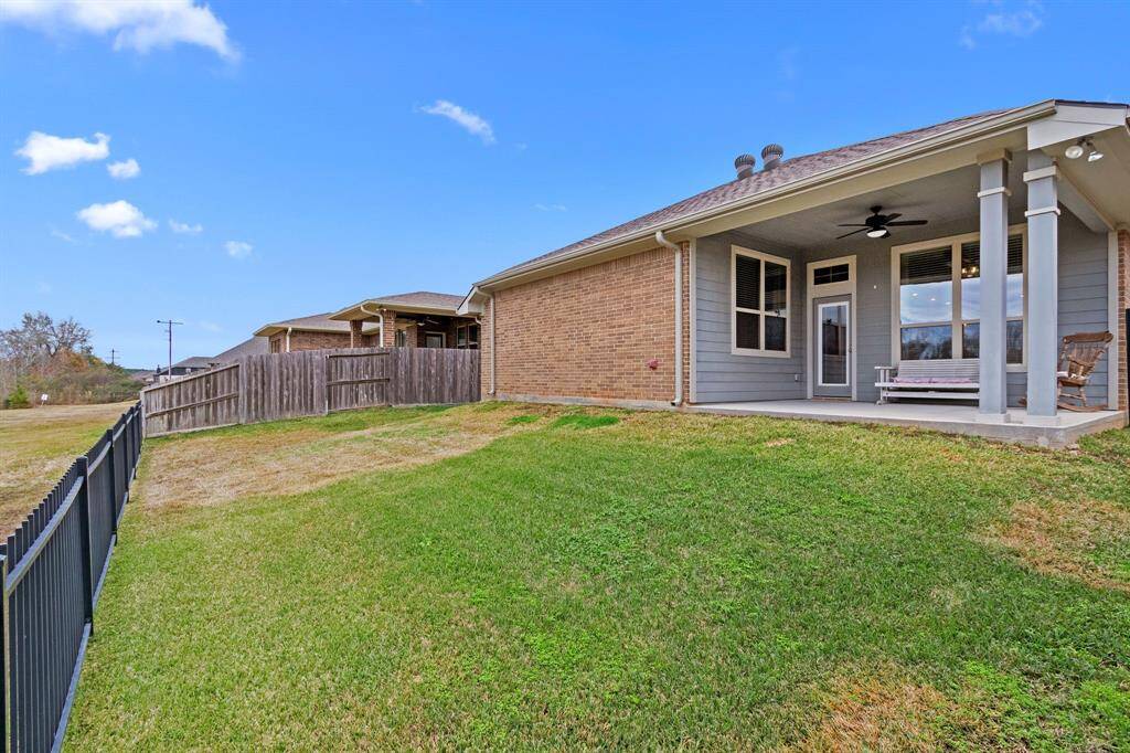 This covered back porch is the perfect spot to sit and drink your coffee or relax while watching your family play!