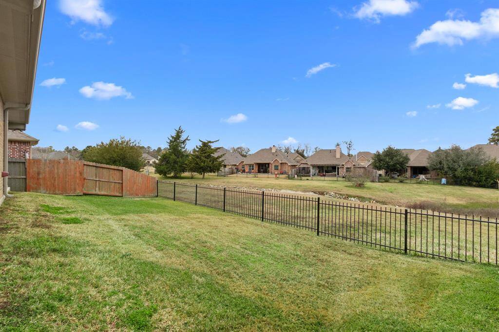A yard big enough for kids to play or your furry friend to run around! Notice the iron fencing?