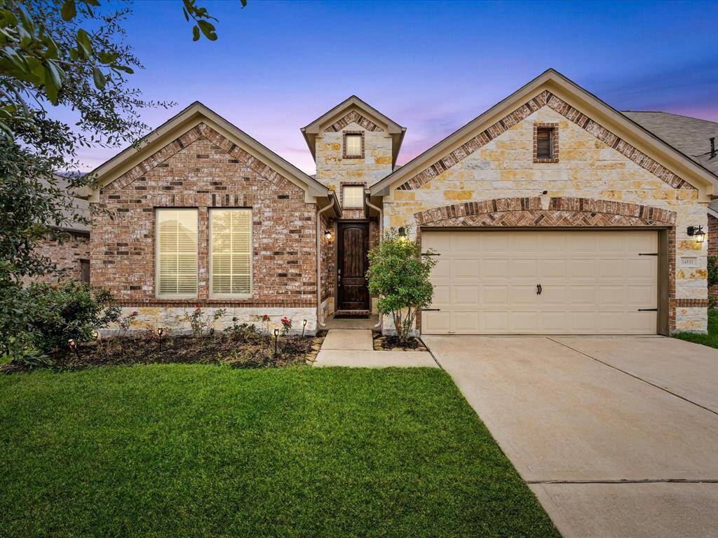 Charming single-story brick home with a two-car garage and a well-maintained front yard. Features a welcoming entryway and attractive landscaping. Perfect for comfortable living.