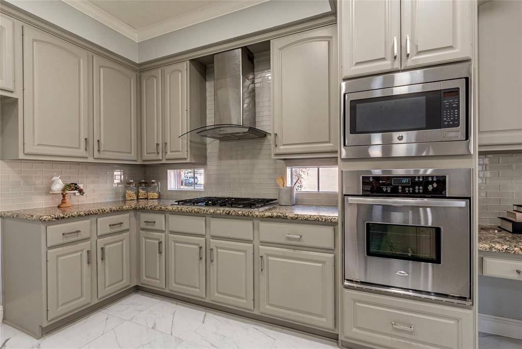 Kitchen accent windows provide amble nature light for cooking; designer subway tile backsplash behind the recently updated vent hood.