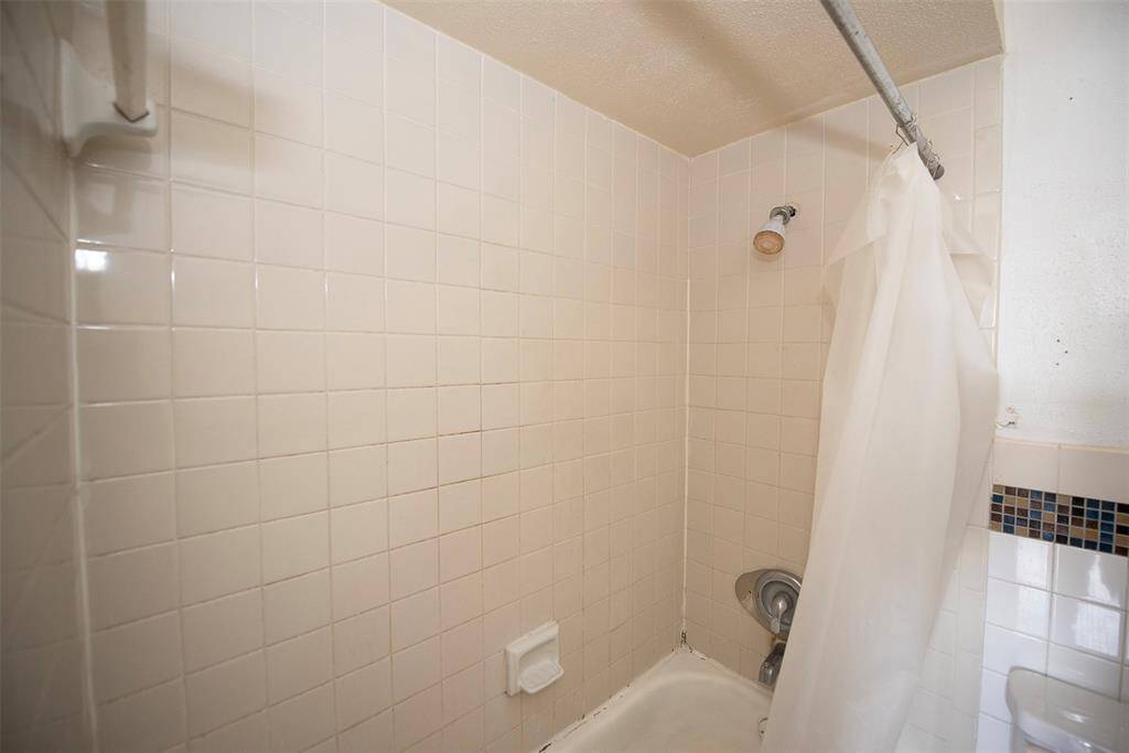 Bathroom features a combo bath and shower too.