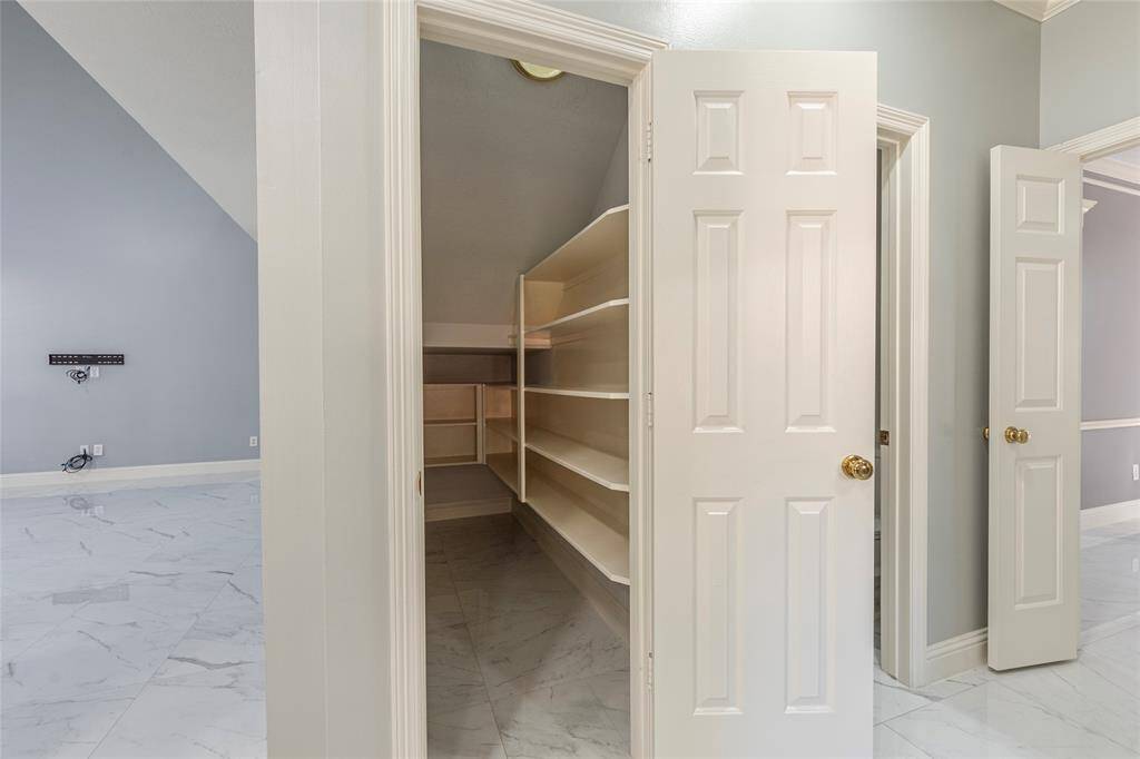 Spacious walk-in pantry with built in storage shelves and ample space for small appliances too.