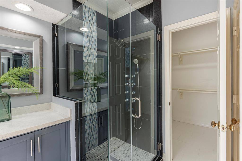 A closer look at the stunning seamless glass walk-in shower with full body sprays, removable wand shower handle and oversized shower head.
