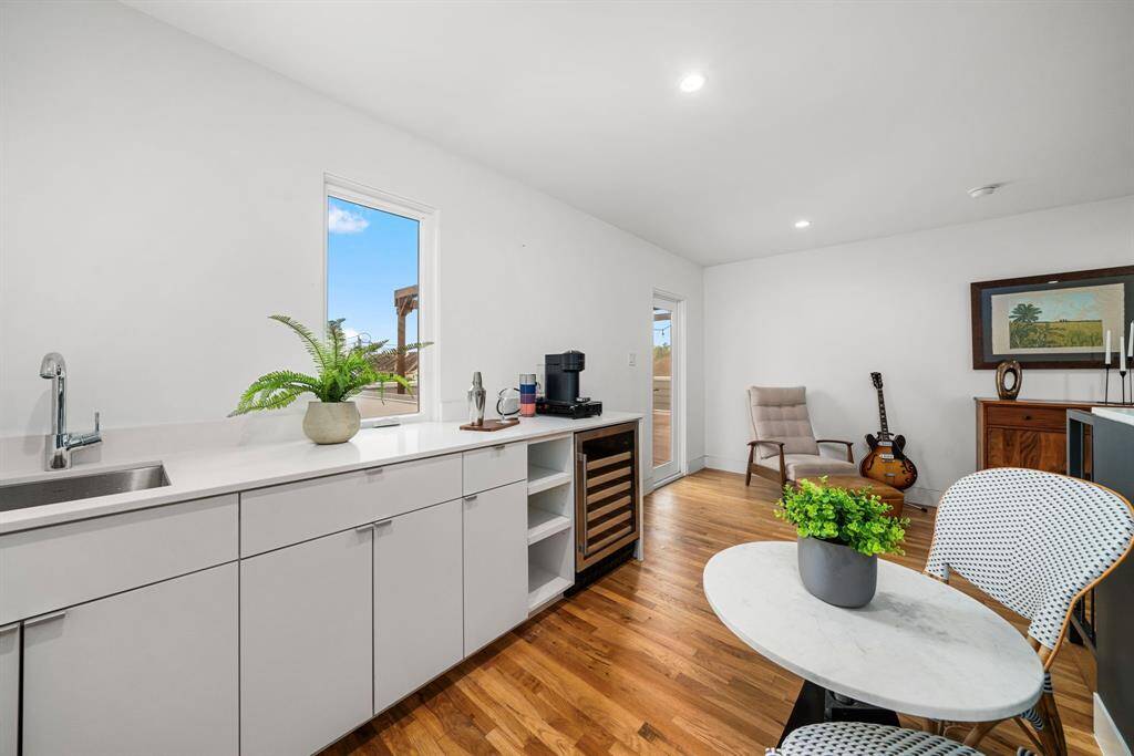 3rd floor kitchenette equipped with sink, as well as beverage fridge.
