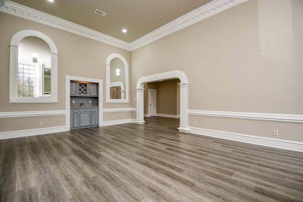 This well-appointed full bathroom, conveniently located off the game room, offers a comfortable and stylish retreat. The vanity features a spacious countertop, ample storage, and a large mirror, while the separate tub and toilet area ensures privacy and convenience.