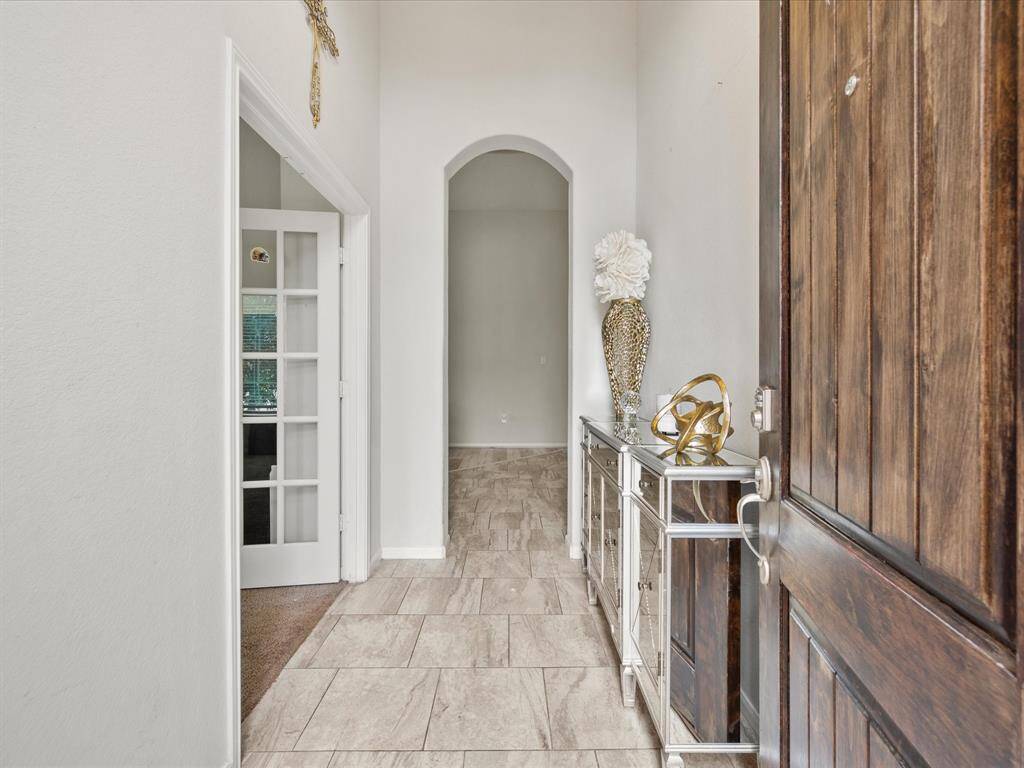 Inviting entryway with elegant tile flooring and high ceilings!
