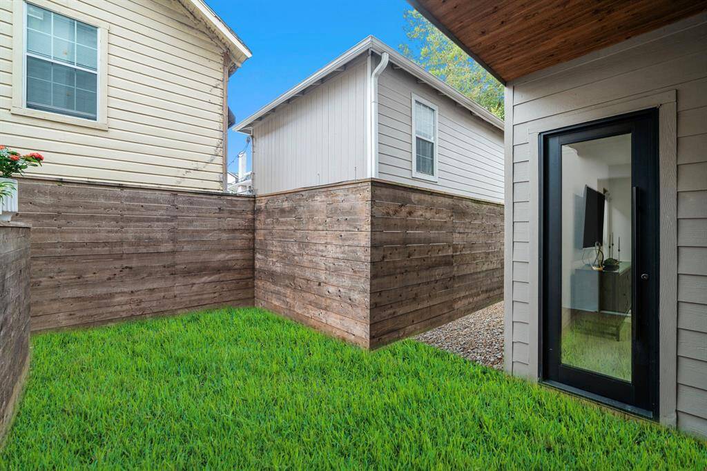 Need grass? No problem! This image is a virtual rendering converting the deck area into green space. Additional fenced outdoor space to the left and right.