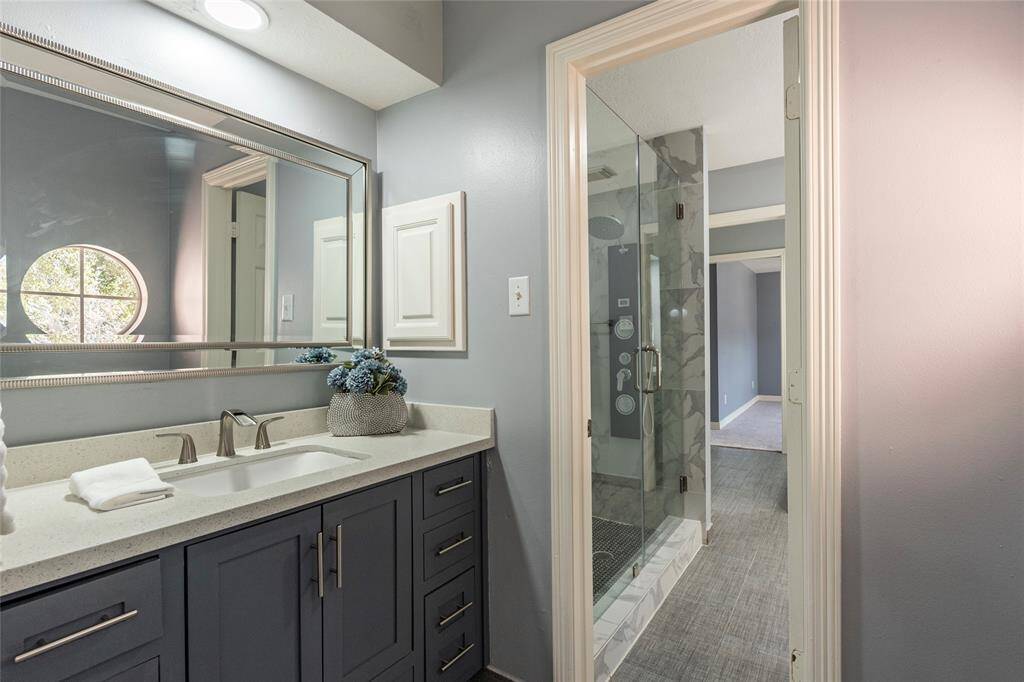 Updated 2nd full bathroom upstairs Jack n Jill style with updated walk-in seamless glass shower, framed mirror and Quartz countertops.