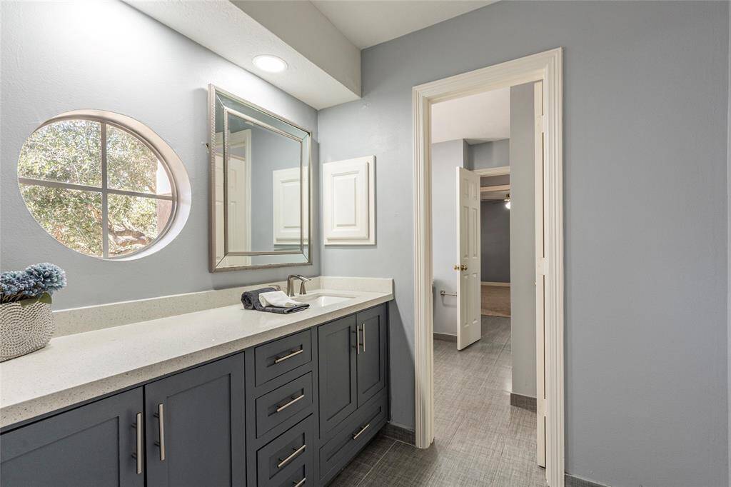 2nd vanity of the Jack N Jill bathroom with Quartz countertops, storage drawers and window for natural light.