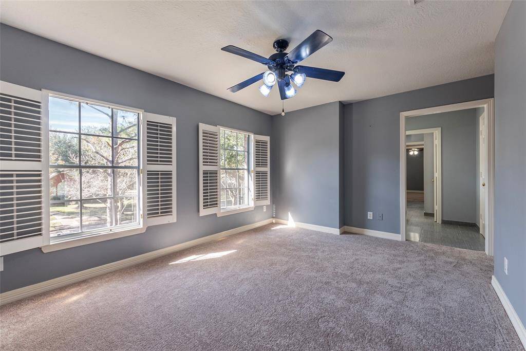 3rd bedroom with NEW carpet is spacious with Plantation shutters, neutral paint tones and walk-in closet.