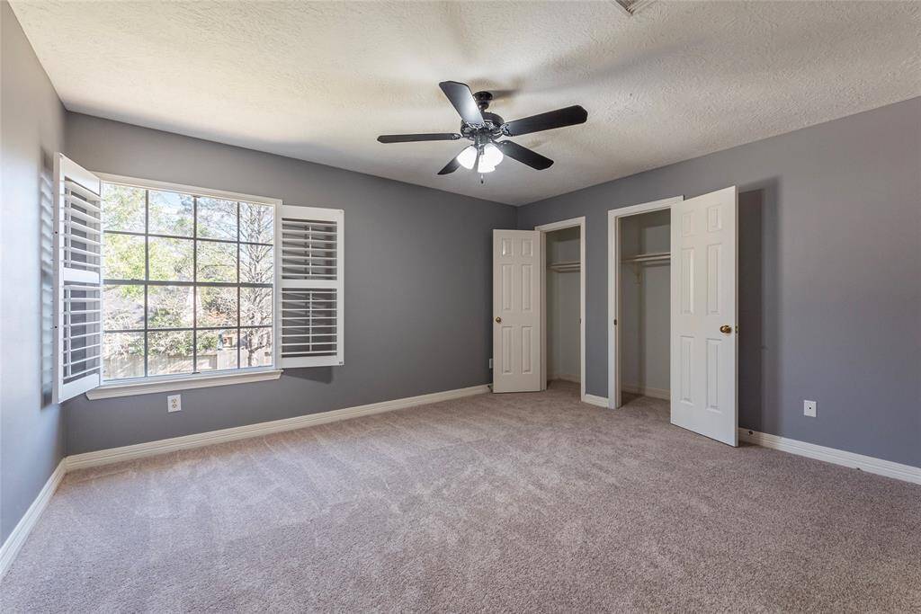 4th bedroom with NEW carpet is large featuring Plantation shutters, updated ceiling fan and double door closet storage.