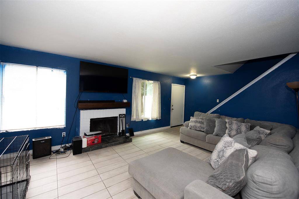 Another view of the spacious living area and there is even a fireplace for the cooler winter months.