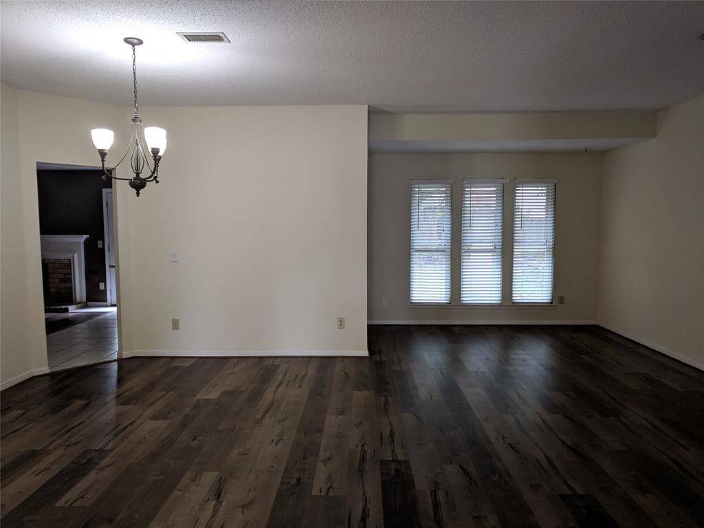 Den/formal living room with luxury vinyl wood flooring