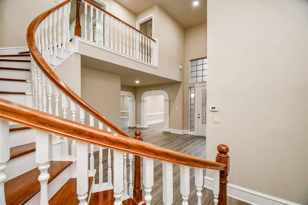 Enjoy entertaining your guests in this formal living room complete with fireplace, floor to ceiling windows, wet bar, and stunning mirrors to enhance the size & beauty of this amazing space!