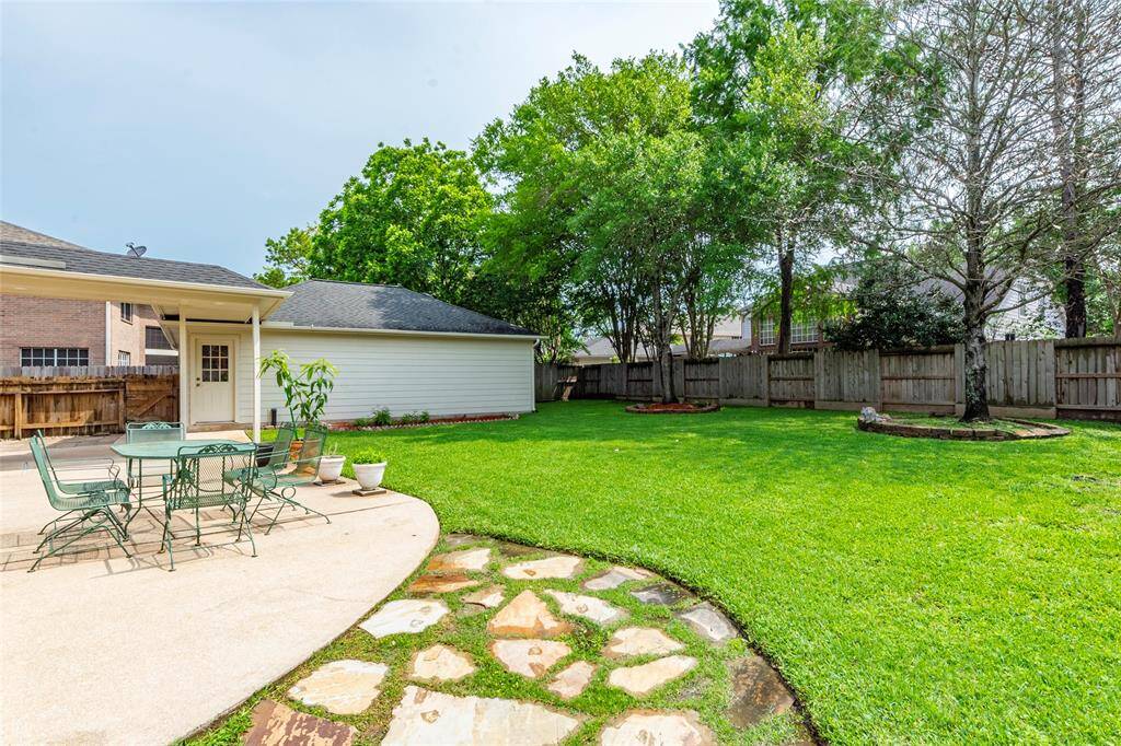 This spacious backyard and patio features room for all outdoor activities or gardening. Patio decking and lush landscaping.