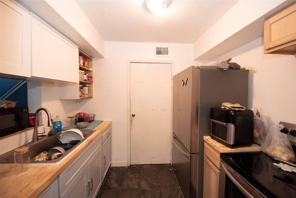 Kitchen with great cabinet space. Through the door is a spacious pantry and place for your washer and dryer.