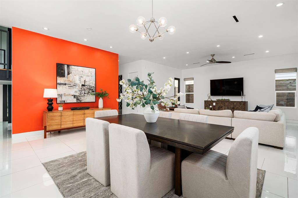 Living and dining seamlessly connect, yet design elements like this accent wall clearly definite each space.