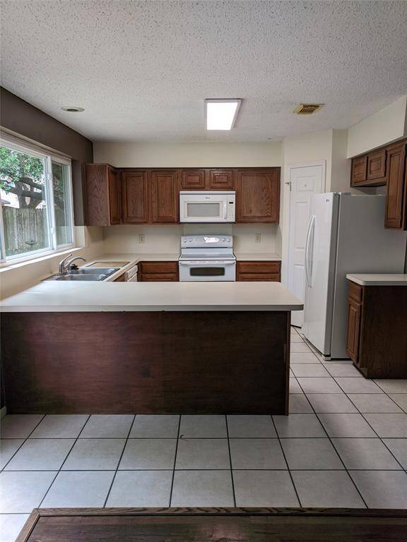 Kitchen with refrigerator