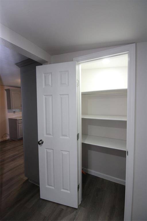 pantry with open shelves, perfect for additional storage. It's conveniently located near the kitchen area.